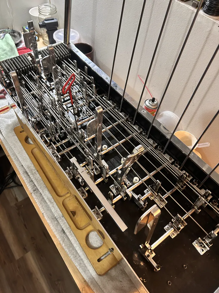 The same mechanism from the pedal end, rods running the length of the body
