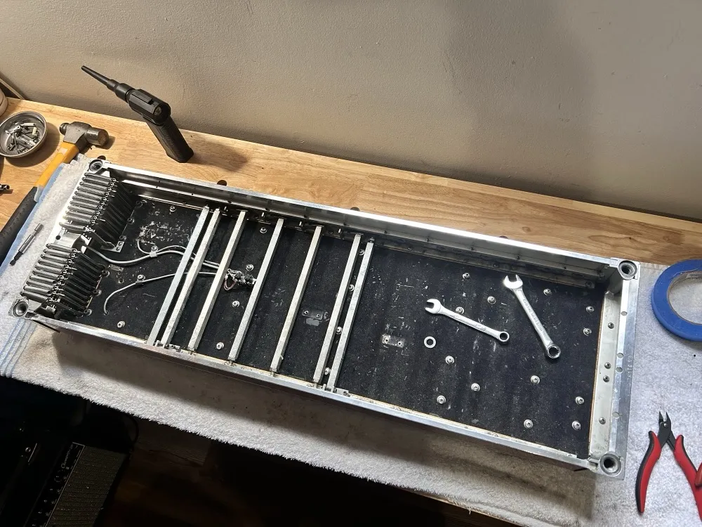 A pedal steel body stripped down to its cross rails and return springs