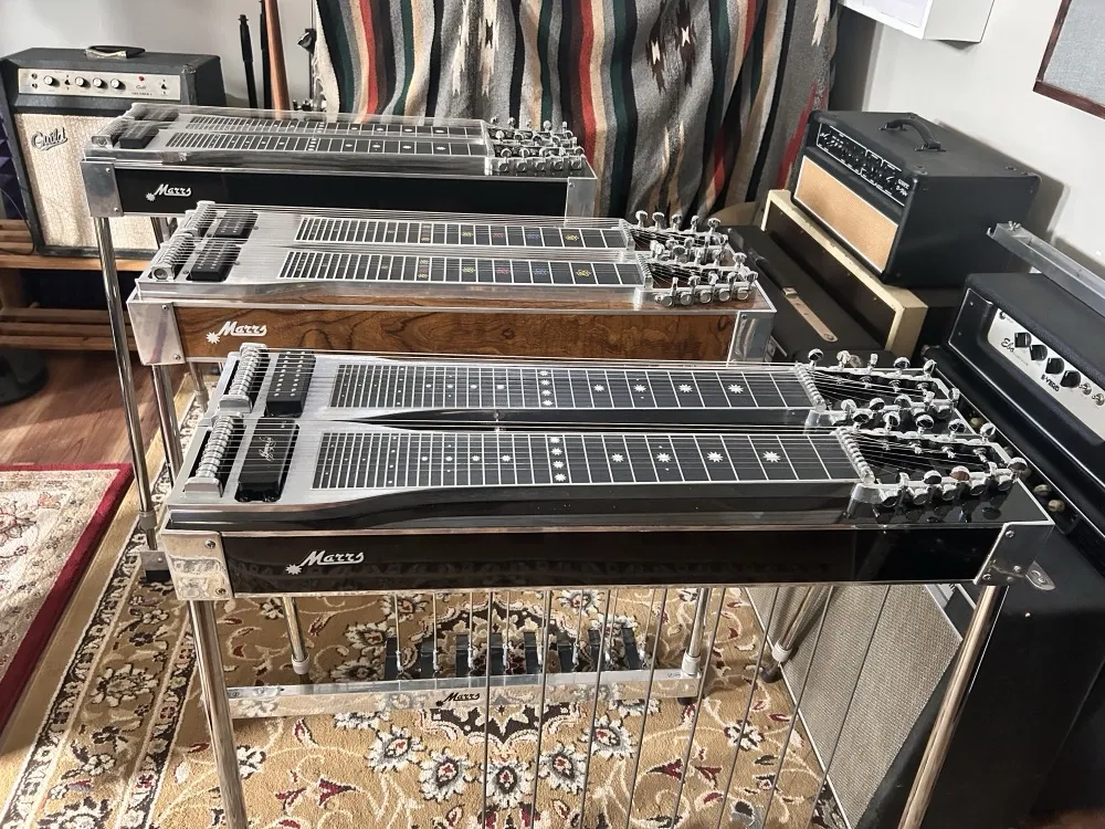 Three Marrs double-neck pedal steels lined up in front of the amps