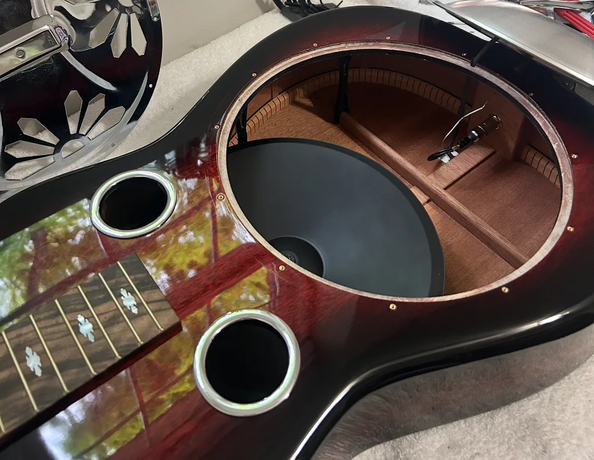 A resonator guitar with its cover off, showing the cone inside