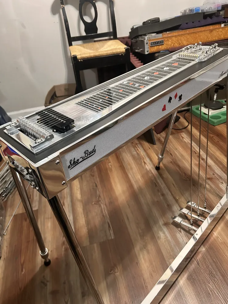 A silver Sho-Bud single-neck pedal steel, back on its legs